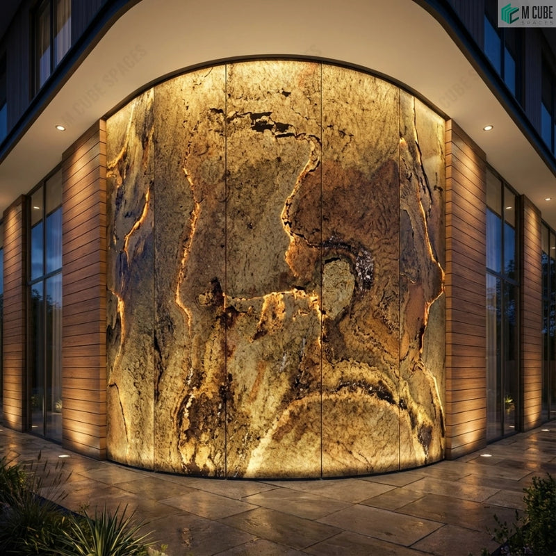 Curved exterior façade with dramatic illuminated Peacock Rock Stone Veneer